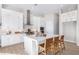 Modern kitchen boasts white cabinetry, a center island with seating, and stainless steel appliances for a gourmet experience at 5741 E Star Valley St, Mesa, AZ 85215