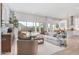 Bright and airy living room featuring a large sectional sofa, stylish decor, and seamless access to the outdoors at 5741 E Star Valley St, Mesa, AZ 85215