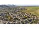 Aerial view of a residential community with pools, mountains, and farmland in the background at 586 E Stirrup Ln, San Tan Valley, AZ 85143