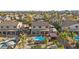 Expansive backyard featuring a large pool, covered patio, hot tub and lush landscaping at 586 E Stirrup Ln, San Tan Valley, AZ 85143