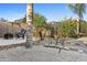 Lush backyard featuring a cozy seating area with outdoor chairs and a charming bridge, creating a tranquil retreat at 586 E Stirrup Ln, San Tan Valley, AZ 85143