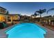 Inviting backyard with a sparkling pool, a relaxing hot tub, and comfortable lounge area at 586 E Stirrup Ln, San Tan Valley, AZ 85143
