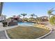 Expansive backyard featuring a sparkling pool, outdoor seating, lush greenery, and a charming spa area at 586 E Stirrup Ln, San Tan Valley, AZ 85143