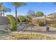 Serene backyard featuring stepping stone pathway, desert landscaping, and custom greenhouse at 586 E Stirrup Ln, San Tan Valley, AZ 85143