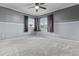 Well-lit bedroom features neutral carpet, ceiling fan, and multiple windows at 586 E Stirrup Ln, San Tan Valley, AZ 85143
