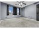 Bedroom features carpet, a ceiling fan, and a double window with view at 586 E Stirrup Ln, San Tan Valley, AZ 85143