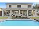 Inviting covered patio with comfortable seating, offering a perfect view of the sparkling pool and serene backyard at 586 E Stirrup Ln, San Tan Valley, AZ 85143