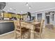 View of the dining area with a wooden table set and seamlessly connecting to the modern kitchen at 586 E Stirrup Ln, San Tan Valley, AZ 85143