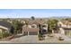 Charming two-story home boasts a well-maintained front yard and a three-car garage, perfect for Gathering living at 586 E Stirrup Ln, San Tan Valley, AZ 85143