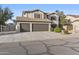 Attractive two-story home featuring a spacious three-car garage and tasteful landscaping, enhancing curb appeal at 586 E Stirrup Ln, San Tan Valley, AZ 85143