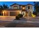 Charming two-story home with a three-car garage and a well-maintained front yard at 586 E Stirrup Ln, San Tan Valley, AZ 85143