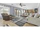 Bright living room featuring a comfortable couch and a sliding door that leads to the backyard at 586 E Stirrup Ln, San Tan Valley, AZ 85143
