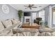Cozy living room with a fireplace, TV, comfortable seating, and a ceiling fan at 586 E Stirrup Ln, San Tan Valley, AZ 85143