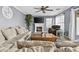 Cozy living room with a fireplace, TV, comfortable seating, and a ceiling fan at 586 E Stirrup Ln, San Tan Valley, AZ 85143