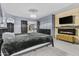 Comfortable bedroom with a modern fireplace, mounted TV, and gray walls at 586 E Stirrup Ln, San Tan Valley, AZ 85143