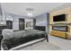 Comfortable bedroom with a modern fireplace, mounted TV, and gray walls at 586 E Stirrup Ln, San Tan Valley, AZ 85143
