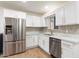 Bright kitchen features white cabinetry, stainless steel appliances, and stylish tile backsplash at 701 W Windsor Ave, Phoenix, AZ 85007