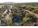 Stunning aerial view of a luxurious home with a private pool, beautifully landscaped backyard, and mature trees at 8057 E Greythorn Dr, Gold Canyon, AZ 85118