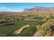 An expansive green golf course is set against a stunning desert landscape and mountain range at 8057 E Greythorn Dr, Gold Canyon, AZ 85118