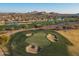 Scenic aerial view of a lush golf course community with ponds and desert landscaping at 8057 E Greythorn Dr, Gold Canyon, AZ 85118