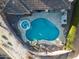 Overhead view of a backyard oasis showcasing a sparkling pool, attached spa, and outdoor lounge area at 8057 E Greythorn Dr, Gold Canyon, AZ 85118