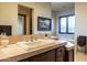 Well-lit bathroom featuring a tile countertop, sink, and a soaking tub, all exuding comfort and style at 8057 E Greythorn Dr, Gold Canyon, AZ 85118