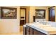 Beautiful bathroom vanity area featuring wood cabinetry, tile countertops, and framed mirrors at 8057 E Greythorn Dr, Gold Canyon, AZ 85118