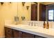 Bright bathroom with a tile countertop, wood vanity, and a well-lit mirror at 8057 E Greythorn Dr, Gold Canyon, AZ 85118