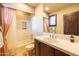 Charming bathroom featuring a tub-shower combo, single vanity, and decorative accents at 8057 E Greythorn Dr, Gold Canyon, AZ 85118