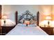 Bedroom featuring a decorative iron bed frame with side tables and lamps at 8057 E Greythorn Dr, Gold Canyon, AZ 85118