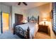 Inviting bedroom features a decorative wrought-iron bed frame, wooden nightstands, and a ceiling fan at 8057 E Greythorn Dr, Gold Canyon, AZ 85118