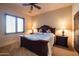 Serene bedroom features a wooden bed frame, bedside tables, and ample natural light at 8057 E Greythorn Dr, Gold Canyon, AZ 85118