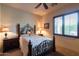 Cozy bedroom featuring a wrought-iron bed frame, wooden nightstands, and natural light at 8057 E Greythorn Dr, Gold Canyon, AZ 85118