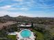 Large community pool and lounge area surrounded by lush landscaping and mountain views at 8057 E Greythorn Dr, Gold Canyon, AZ 85118