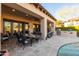 A patio area with comfortable chairs, a BBQ, and fireplace overlooking the pool at 8057 E Greythorn Dr, Gold Canyon, AZ 85118