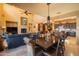 Formal dining room area showcasing a chandelier, hardwood table and easy access to the living room and kitchen at 8057 E Greythorn Dr, Gold Canyon, AZ 85118