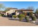 Beautiful home with brick driveway, desert landscaping and flowering vines on the facade at 8057 E Greythorn Dr, Gold Canyon, AZ 85118