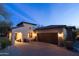 Charming home with stone and stucco exterior, attached garage, and lush landscaping at 8057 E Greythorn Dr, Gold Canyon, AZ 85118