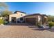 Charming single-Gathering home featuring a brick driveway, desert landscaping, and a two-car garage at 8057 E Greythorn Dr, Gold Canyon, AZ 85118