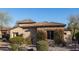 A stunning property featuring vibrant bougainvillea growing on a stone facade, set amongst desert landscaping at 8057 E Greythorn Dr, Gold Canyon, AZ 85118