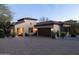 Elegant home with a paver driveway, attached garage, and beautiful desert landscaping at 8057 E Greythorn Dr, Gold Canyon, AZ 85118
