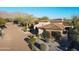 Beautiful home with brick driveway, desert landscaping and flowering vines on the facade at 8057 E Greythorn Dr, Gold Canyon, AZ 85118