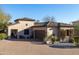 Charming single-Gathering home featuring a brick driveway, desert landscaping, and a two-car garage at 8057 E Greythorn Dr, Gold Canyon, AZ 85118