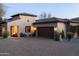 Elegant home with a paver driveway, attached garage, and beautiful desert landscaping at 8057 E Greythorn Dr, Gold Canyon, AZ 85118