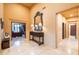 A grand foyer with tile flooring, complemented by the detailed entry table with decorative lamps at 8057 E Greythorn Dr, Gold Canyon, AZ 85118