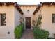 The beautiful, custom wood front door and desert landscaping create excellent curb appeal at 8057 E Greythorn Dr, Gold Canyon, AZ 85118