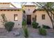 Charming front entrance with a beautiful, ornate door, surrounded by manicured landscaping at 8057 E Greythorn Dr, Gold Canyon, AZ 85118