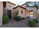 Inviting exterior showcases lush landscaping and classic architecture with a covered walkway at 8057 E Greythorn Dr, Gold Canyon, AZ 85118