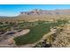 Expansive view of a lush golf course with mountain backdrop, offering a serene and picturesque setting at 8057 E Greythorn Dr, Gold Canyon, AZ 85118