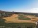 Scenic aerial shot of a pristine golf course surrounded by lush desert landscape, perfect for golfing enthusiasts at 8057 E Greythorn Dr, Gold Canyon, AZ 85118